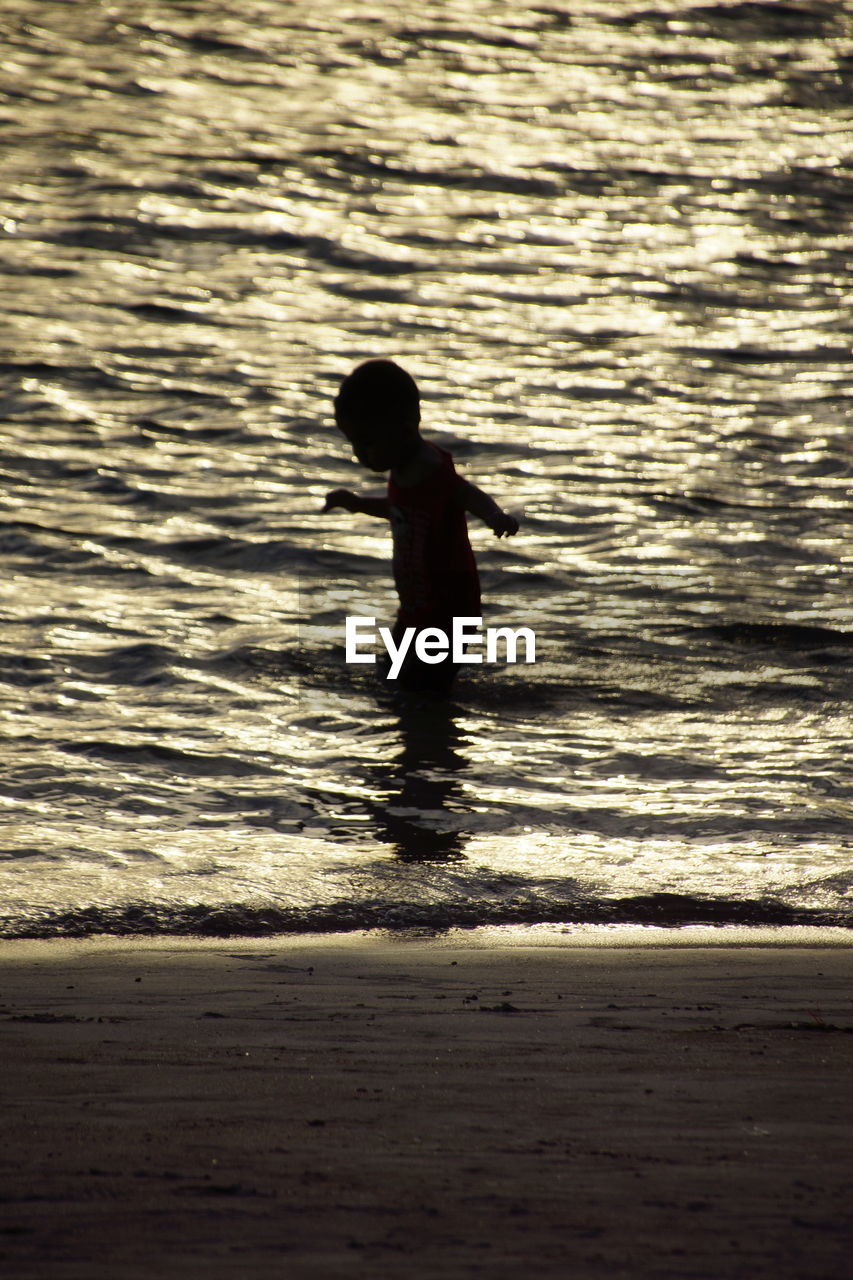 View of boy in sea