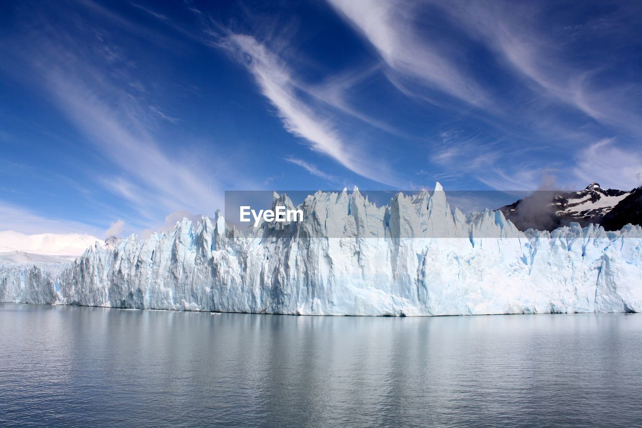 Panoramic view of a spectacular ice fall with water reflection