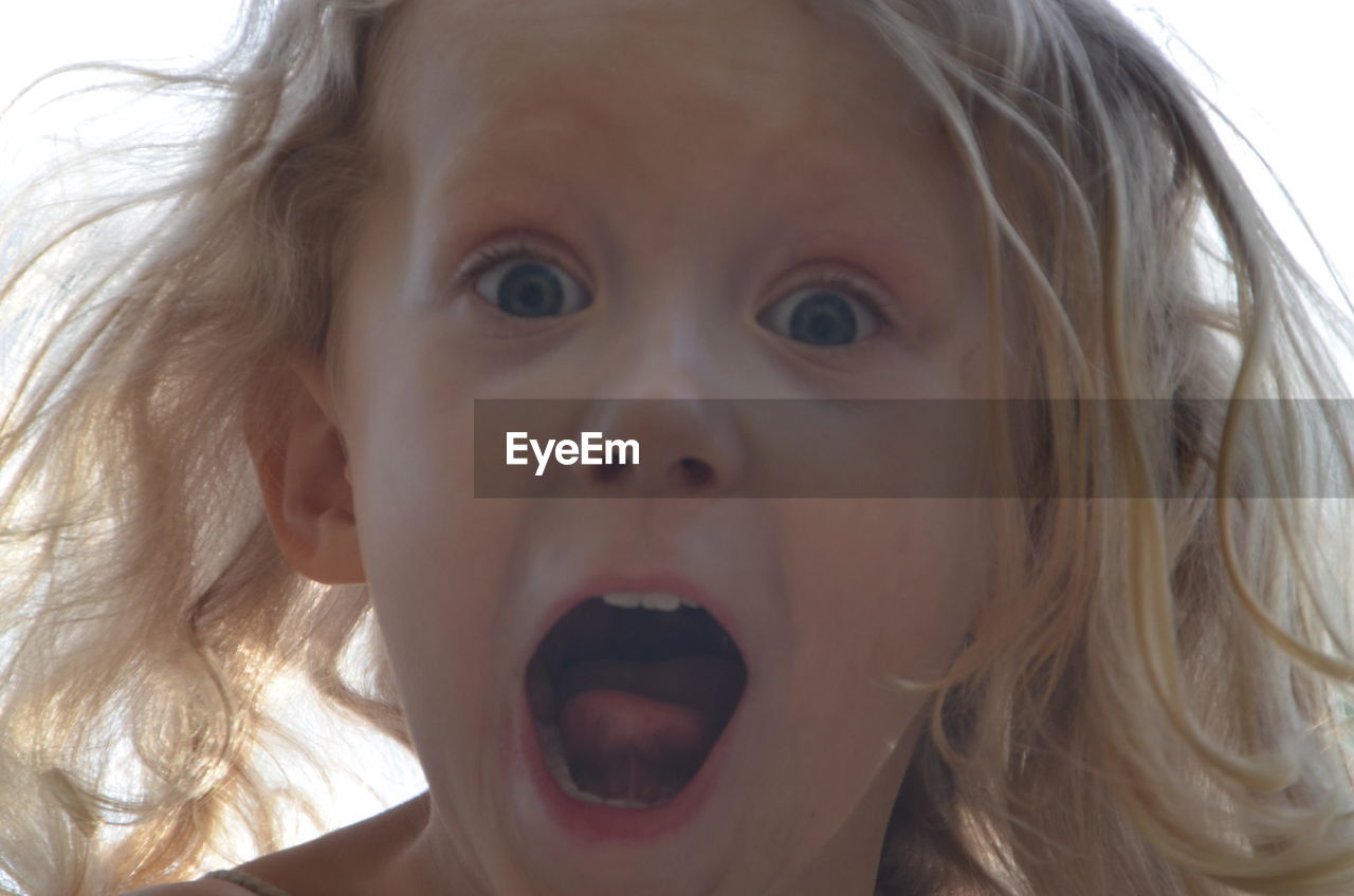 Close-up portrait of girl screaming outdoors