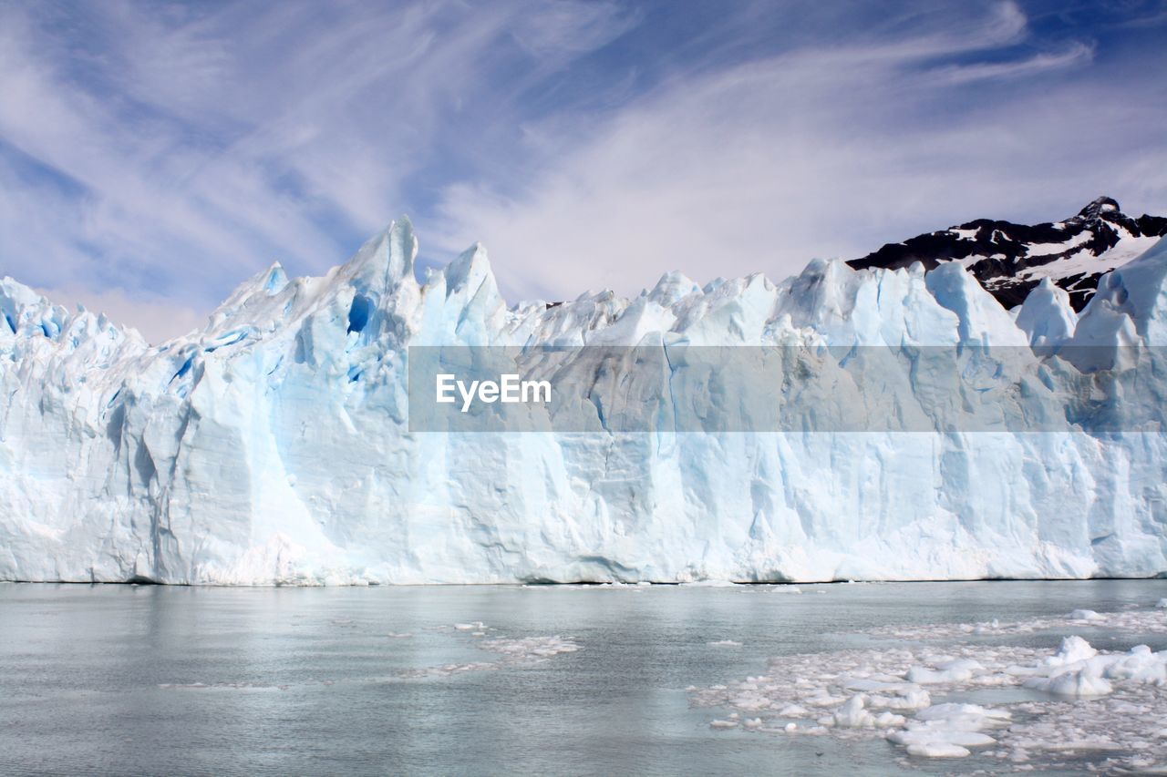 Spectacular ice fall reflected on the surface of the sea