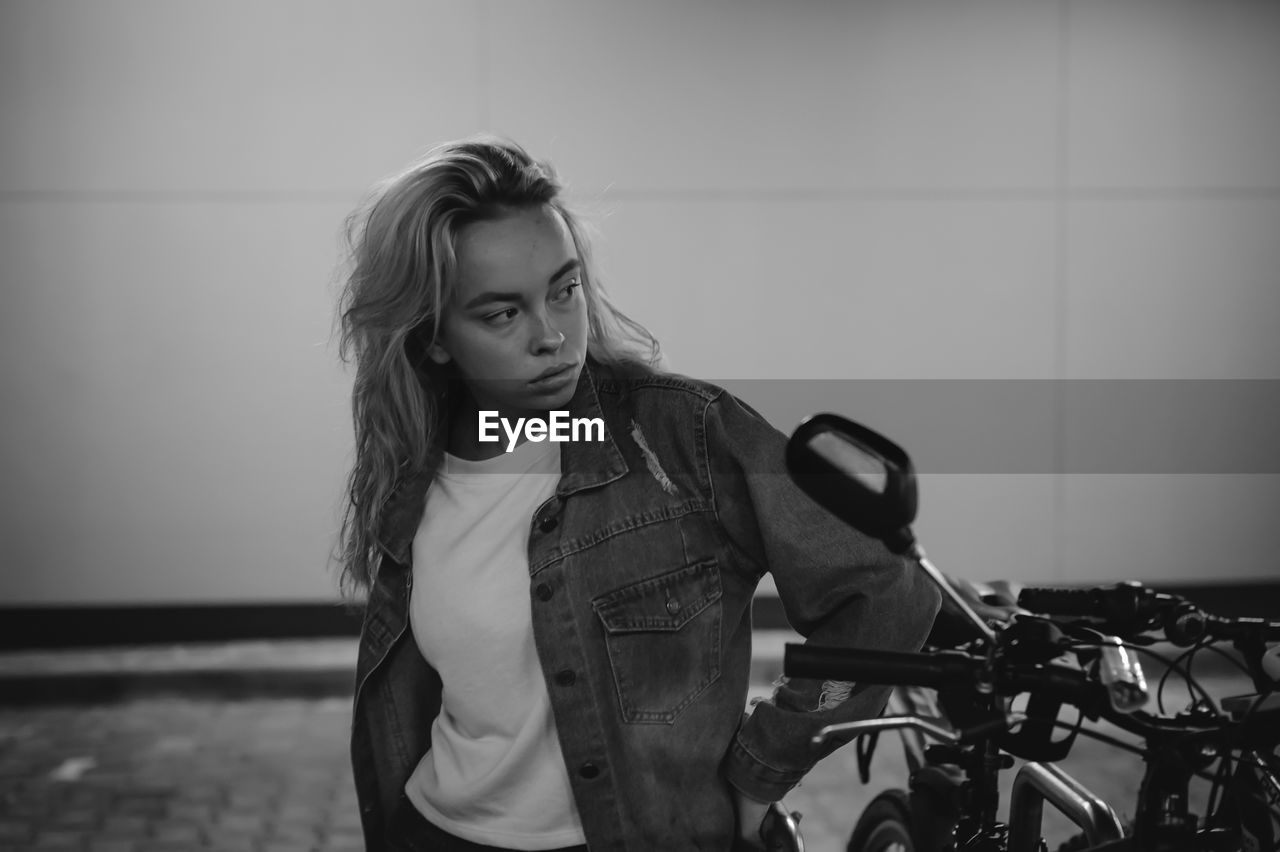 Woman standing by bicycle at basement