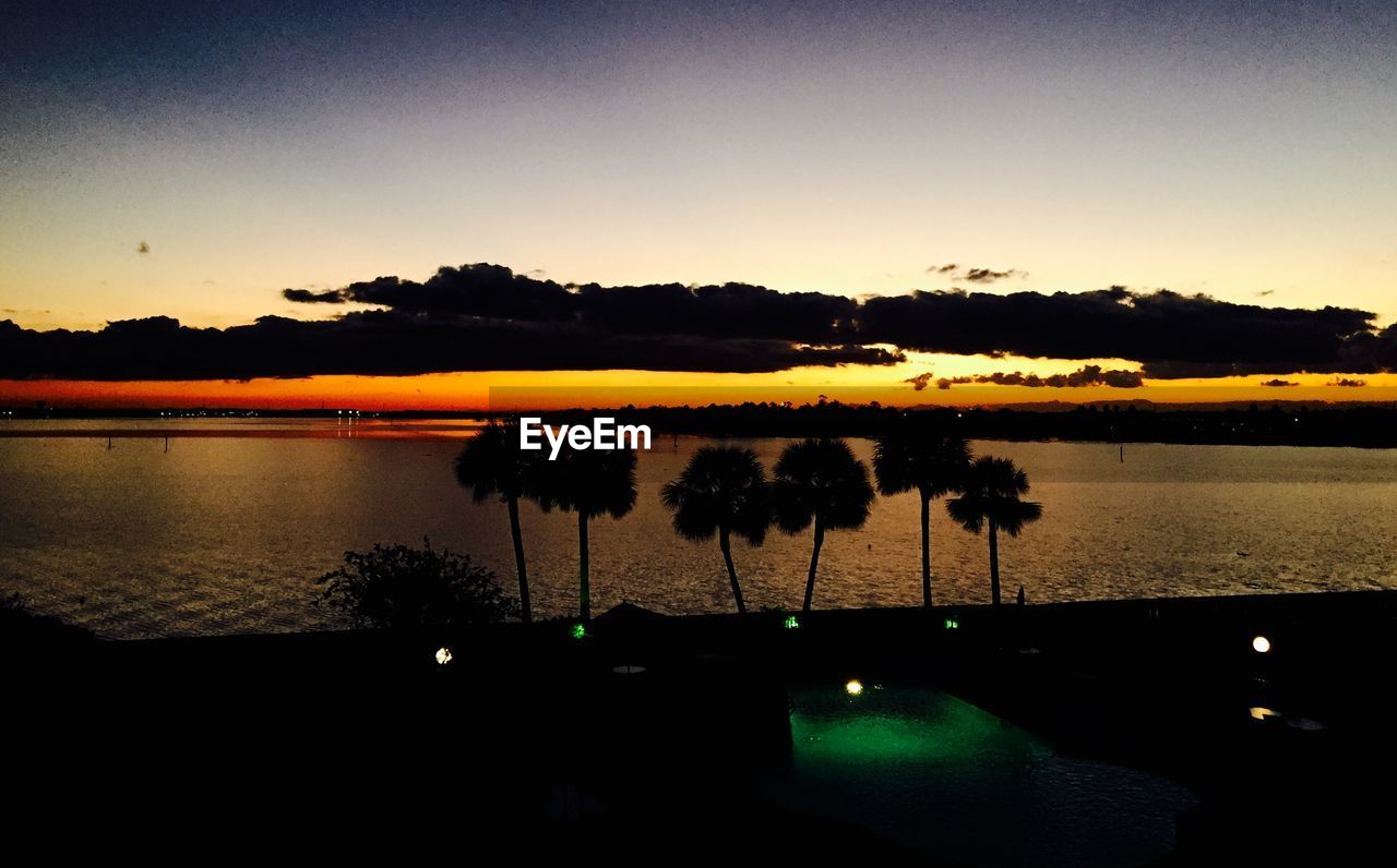 SCENIC VIEW OF SUNSET OVER RIVER