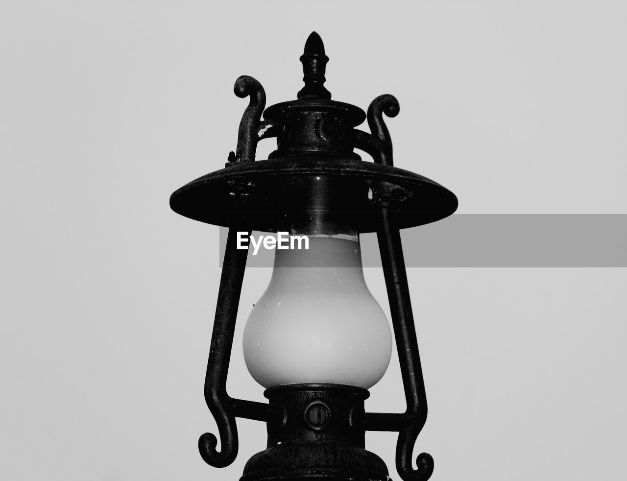 CLOSE-UP OF ELECTRIC LAMP AGAINST WALL