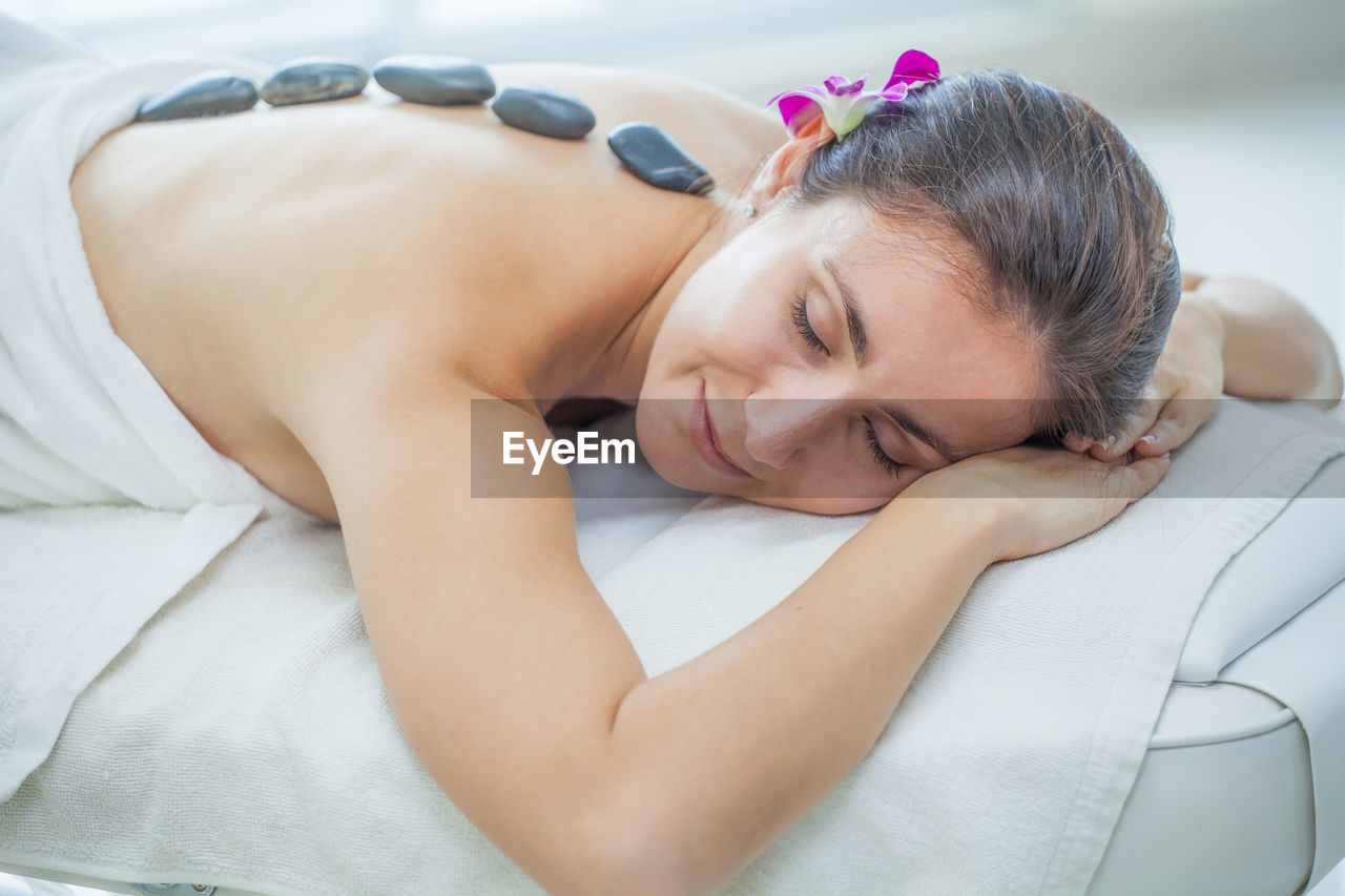 Woman having lastone therapy in spa 