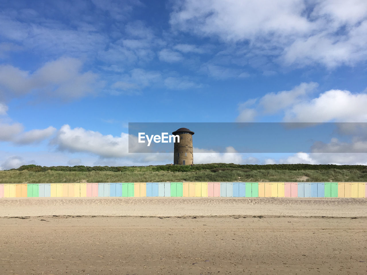 BUILT STRUCTURE ON BEACH AGAINST SKY