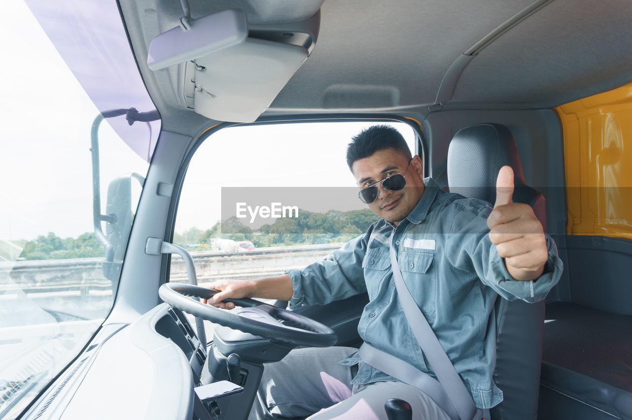 Portrait of man sitting in truck