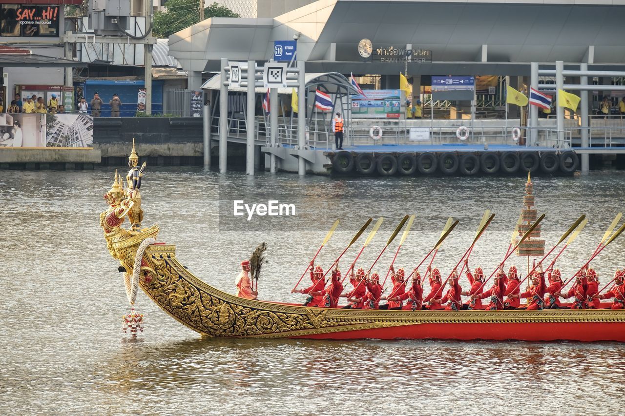 PEOPLE IN RIVER AGAINST BUILDINGS