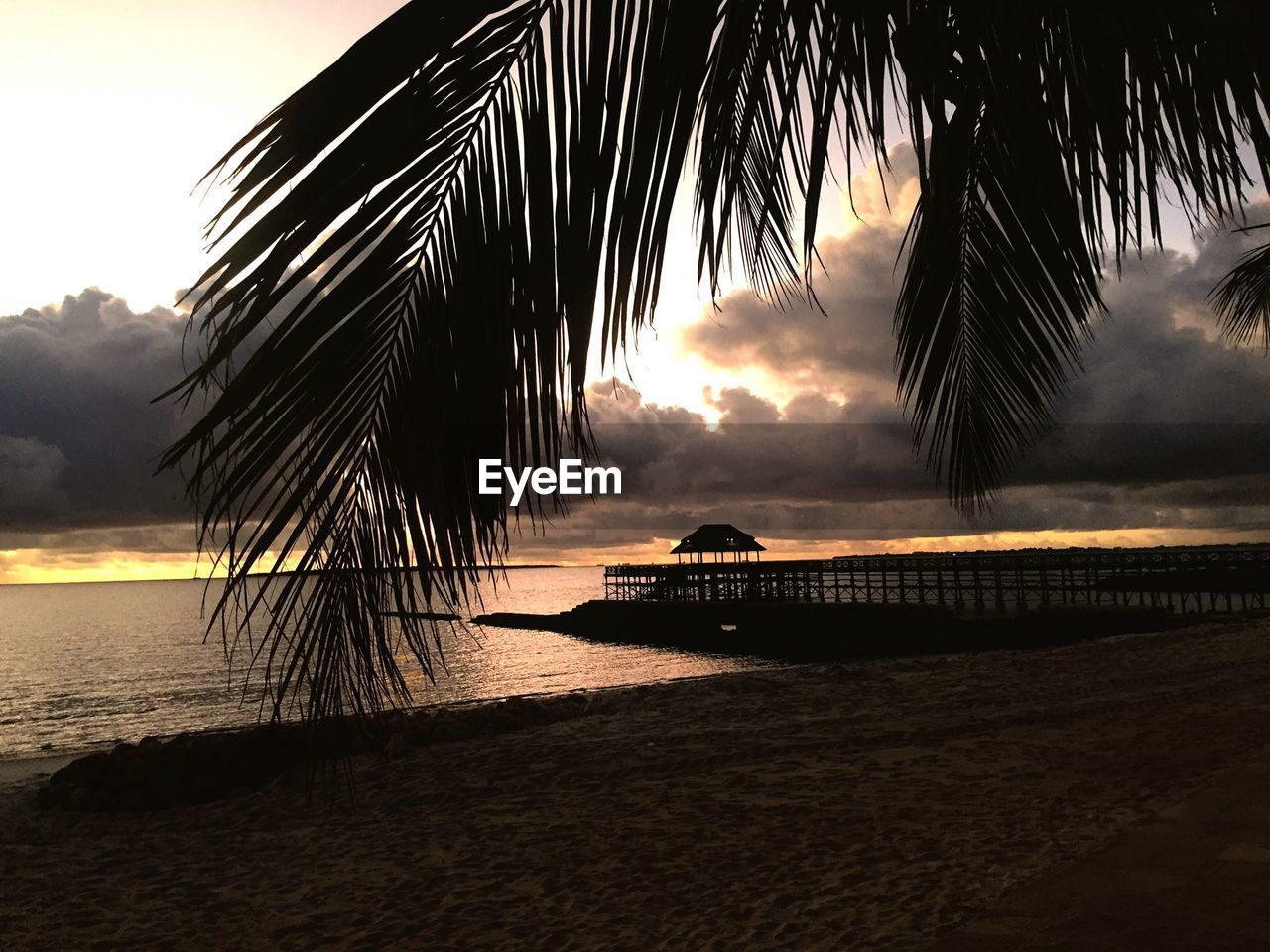 Silhouette of pier at sunset