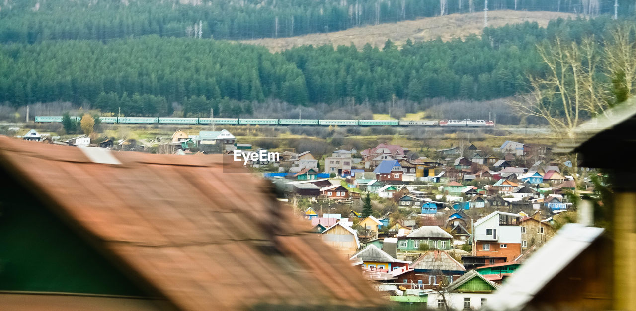 View of village houses and train passing at distant 