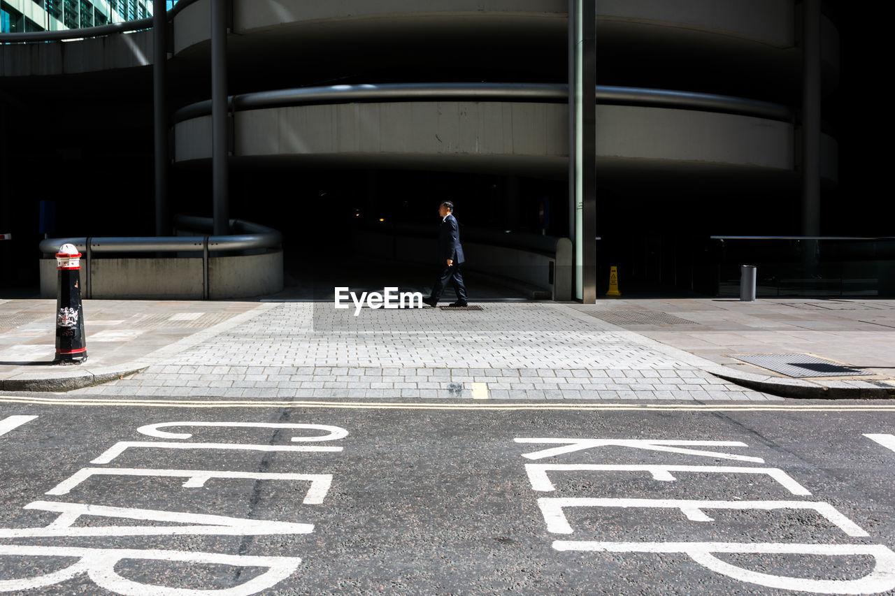 Man walking on road in city