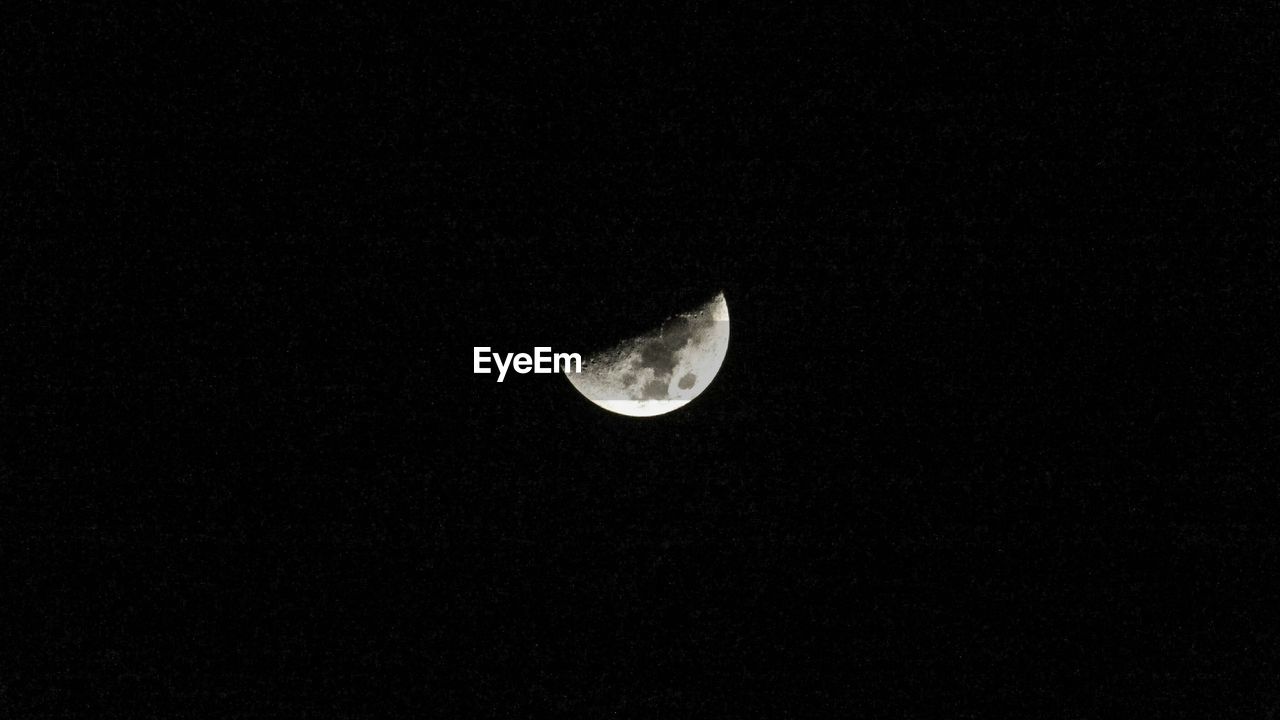 Low angle view of moon at dark surface