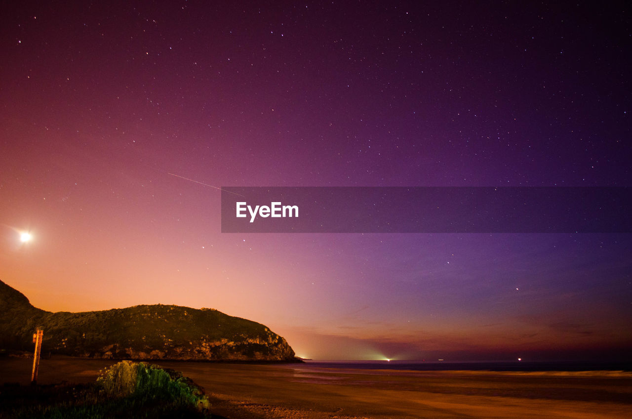 Scenic view of sea against sky at night