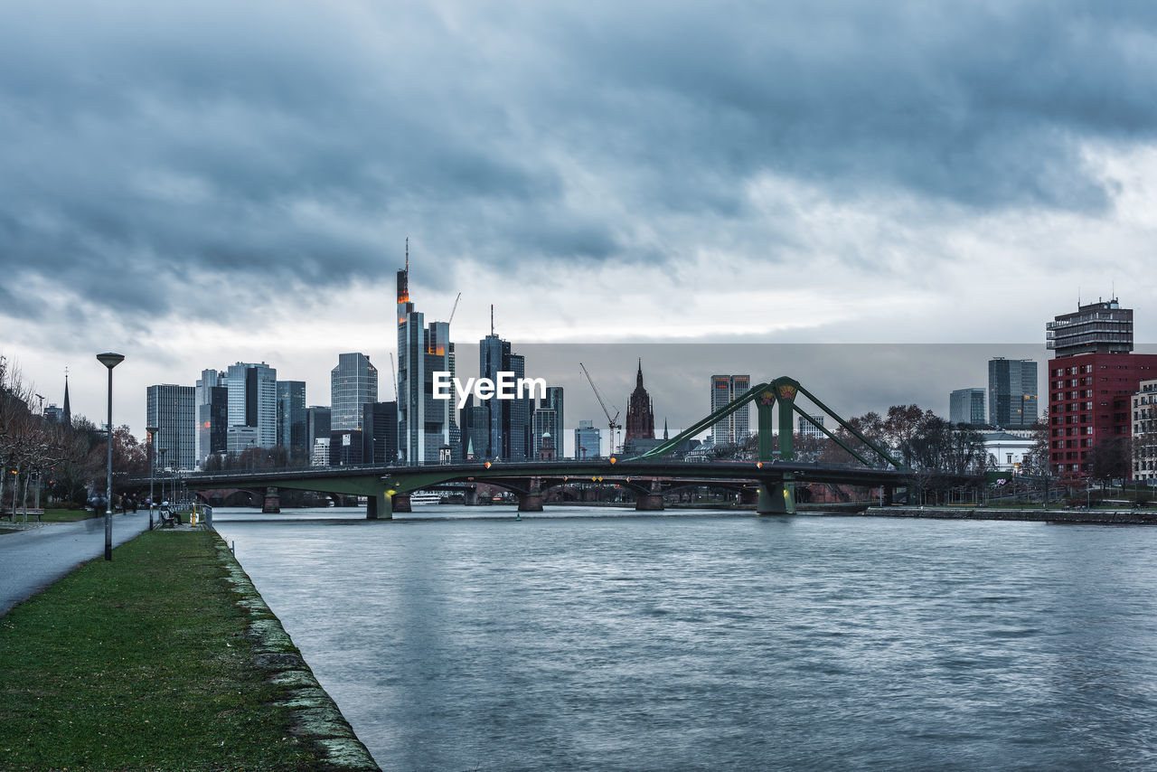 Bridge over river with buildings in background