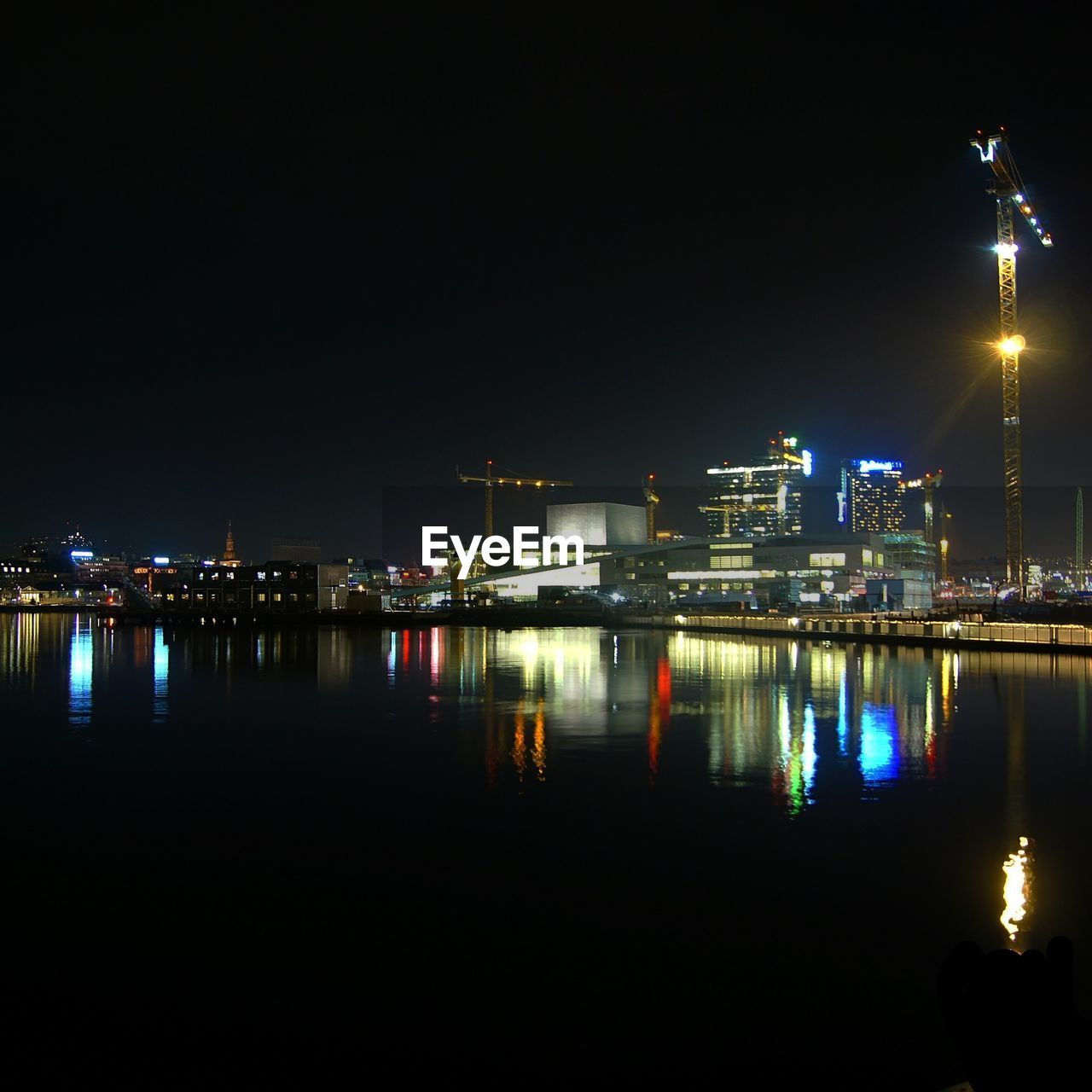 REFLECTION OF ILLUMINATED BUILDINGS IN RIVER