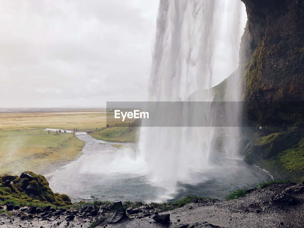 Scenic view of waterfall against sky