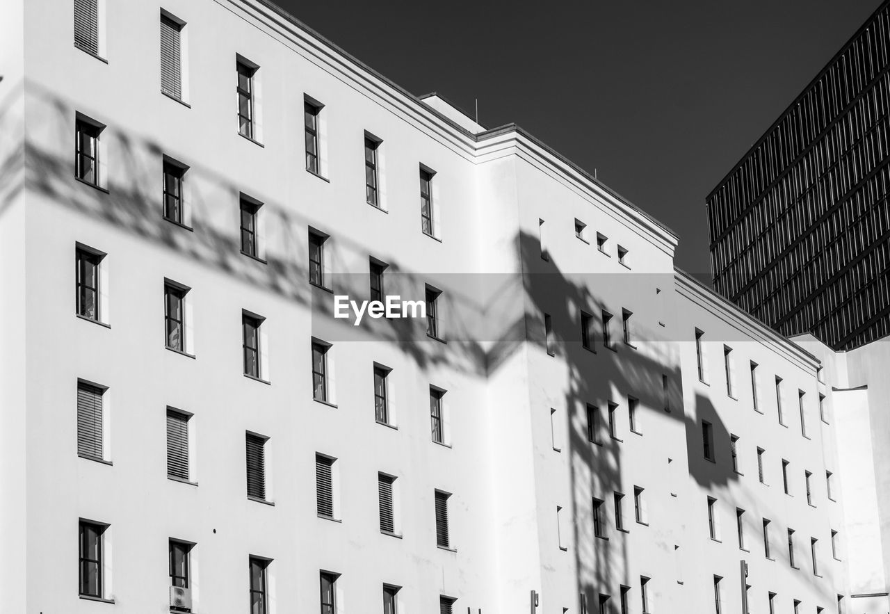 Low angle view of building with shadow in city