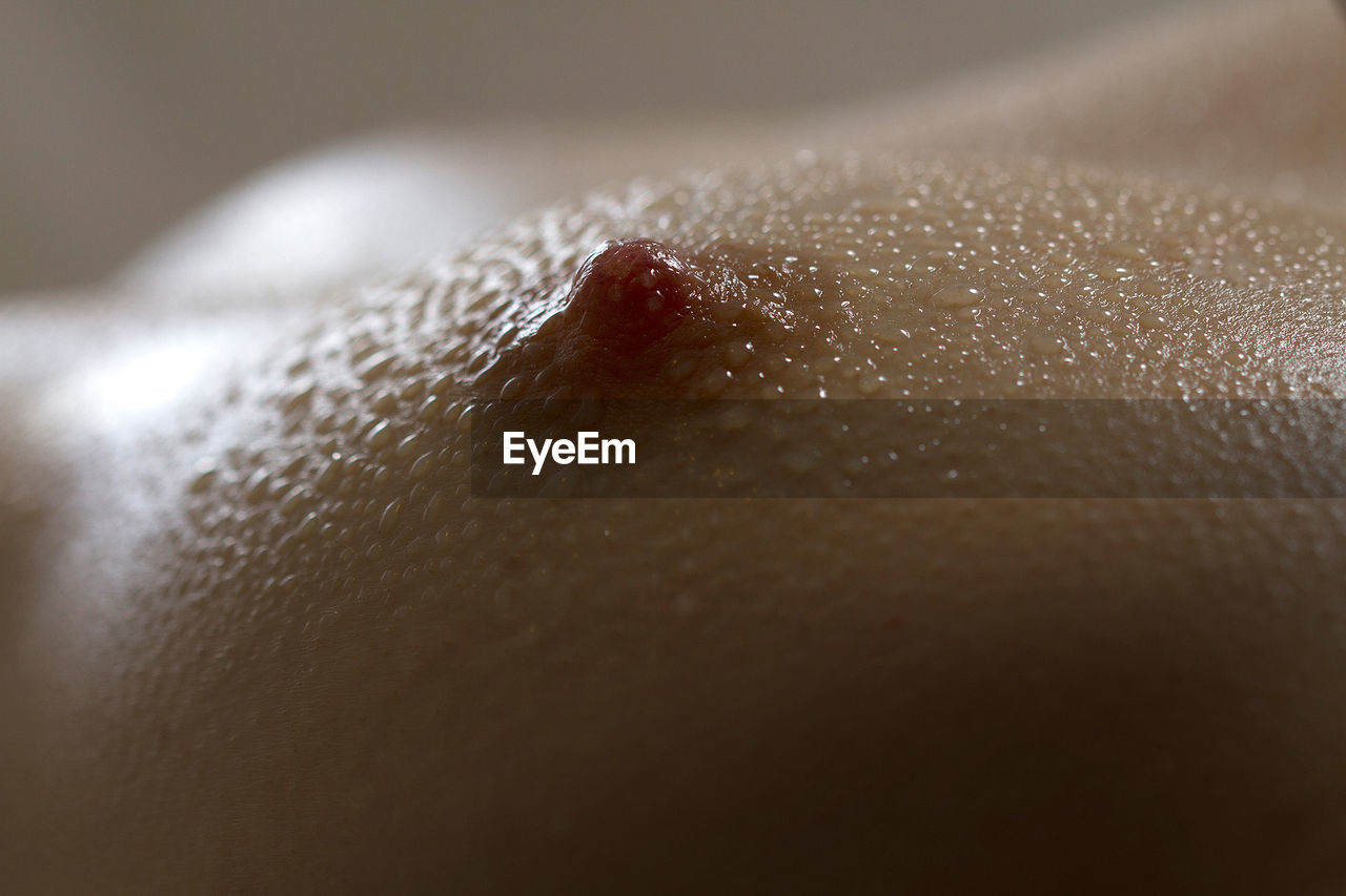 Close-up of water drops on woman breast