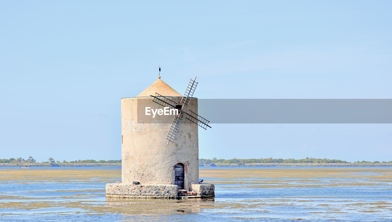 Lighthouse by sea against clear sky-orbetello 