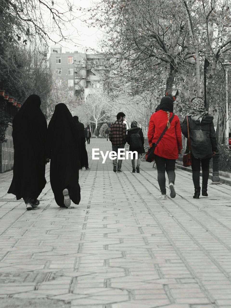 REAR VIEW OF WOMEN WALKING ON FOOTPATH IN SNOW