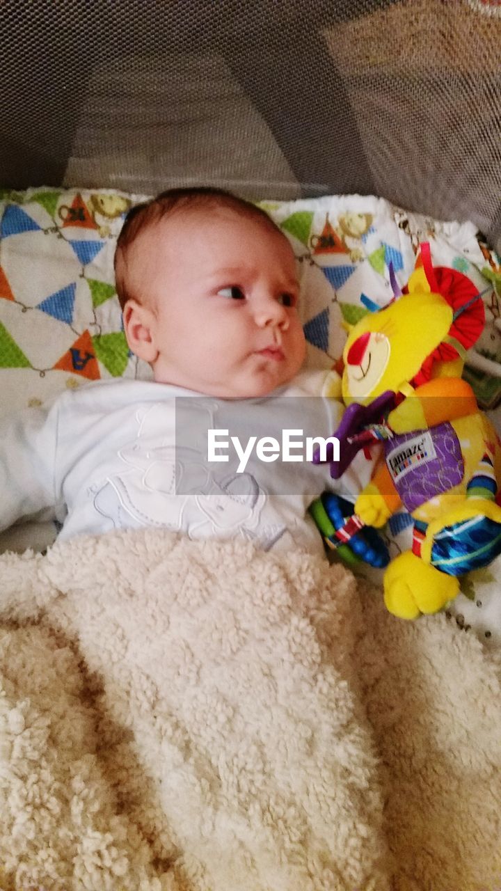 PORTRAIT OF CUTE BABY SLEEPING ON BED