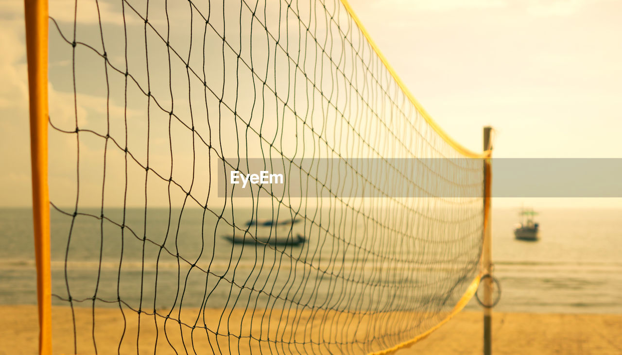 Empty beach volleyball net on the beach with warm tone