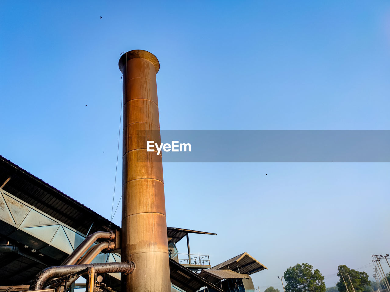 LOW ANGLE VIEW OF SMOKE STACKS AGAINST SKY