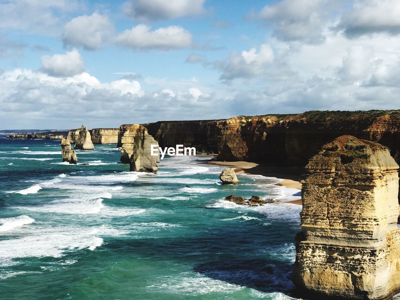 Scenic view of twelve apostles against cloudy sky