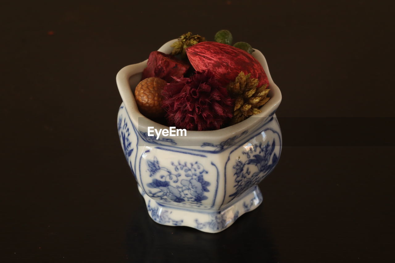 High angle view of tea cup on table against black background