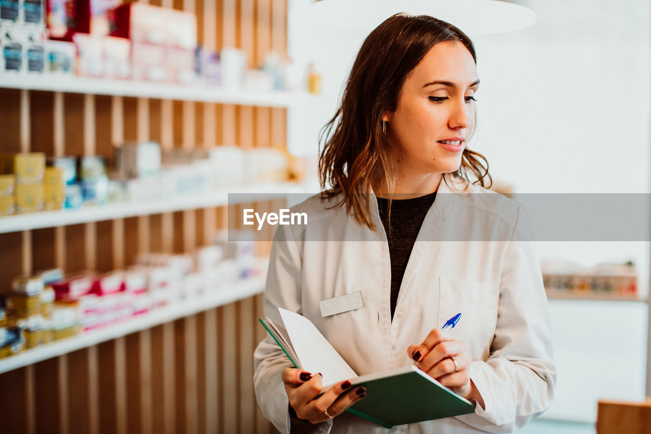 Female pharmacist working at store