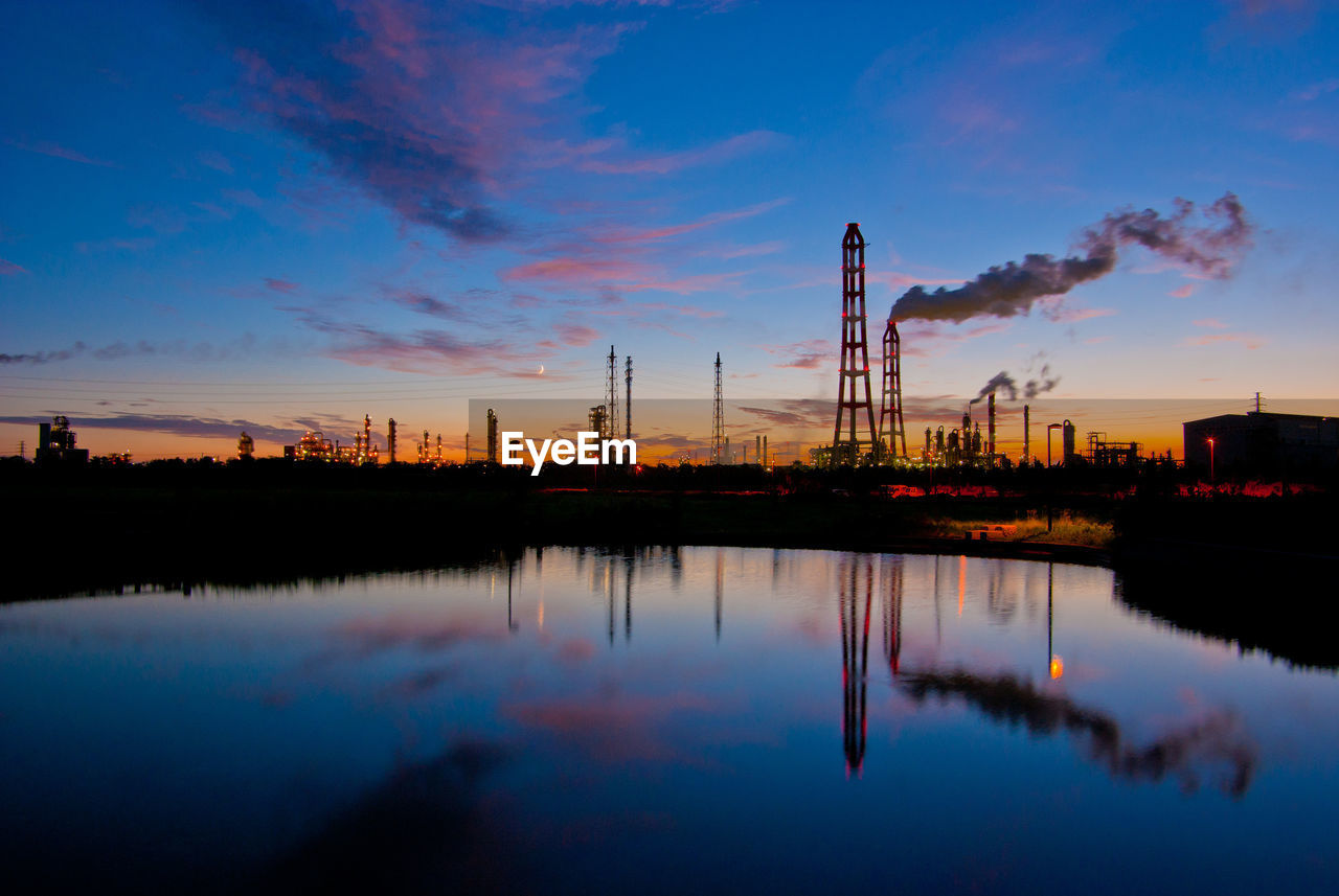 View of factory against sky during sunset