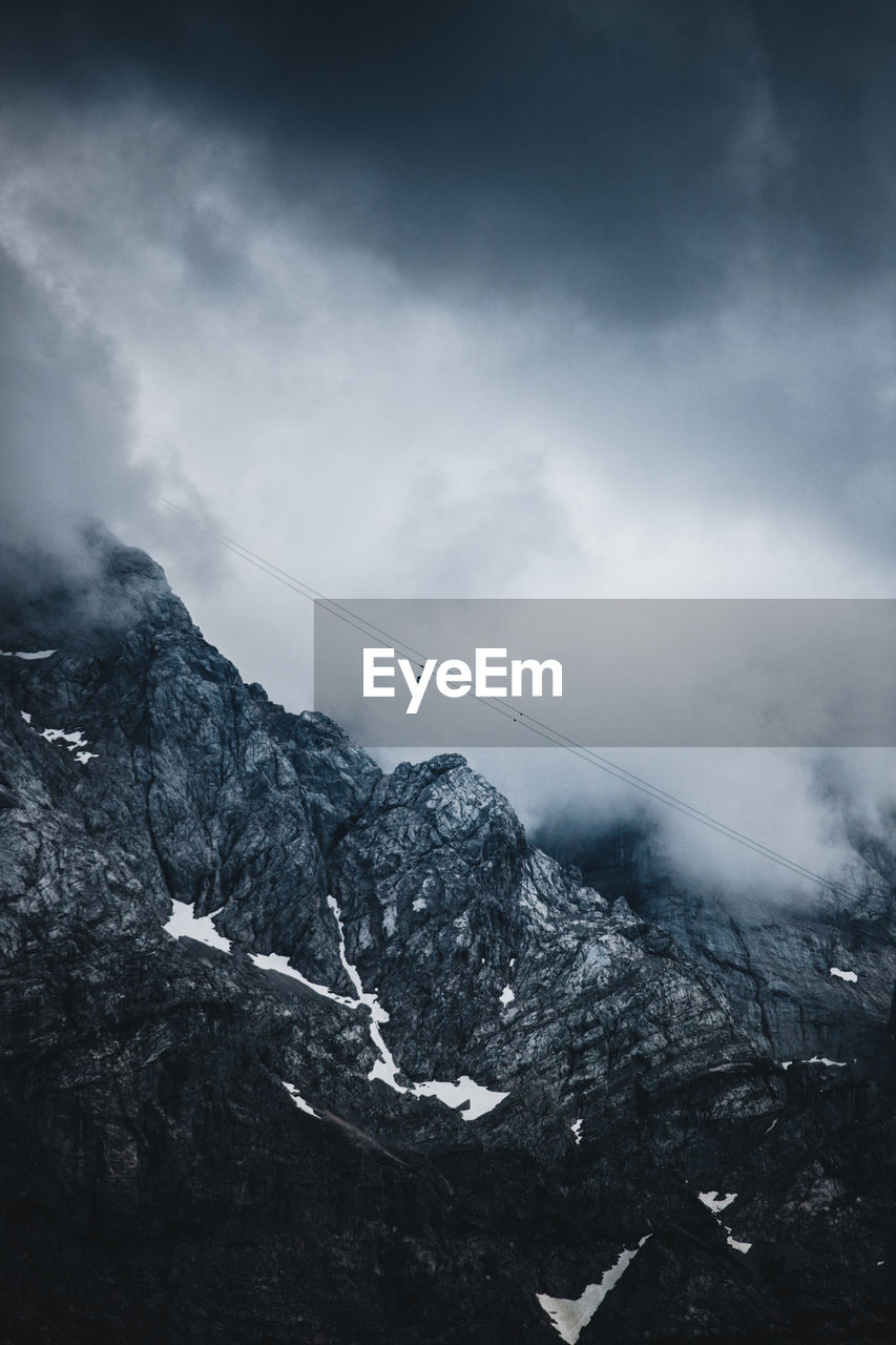 Low angle view of snowcapped mountain against sky