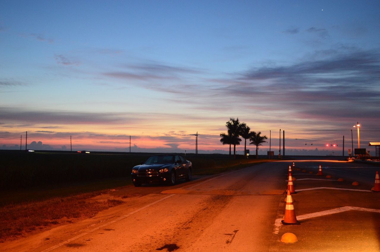 CARS ON ROAD AT SUNSET