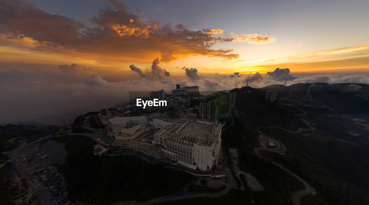 High angle view of buildings in city during sunset