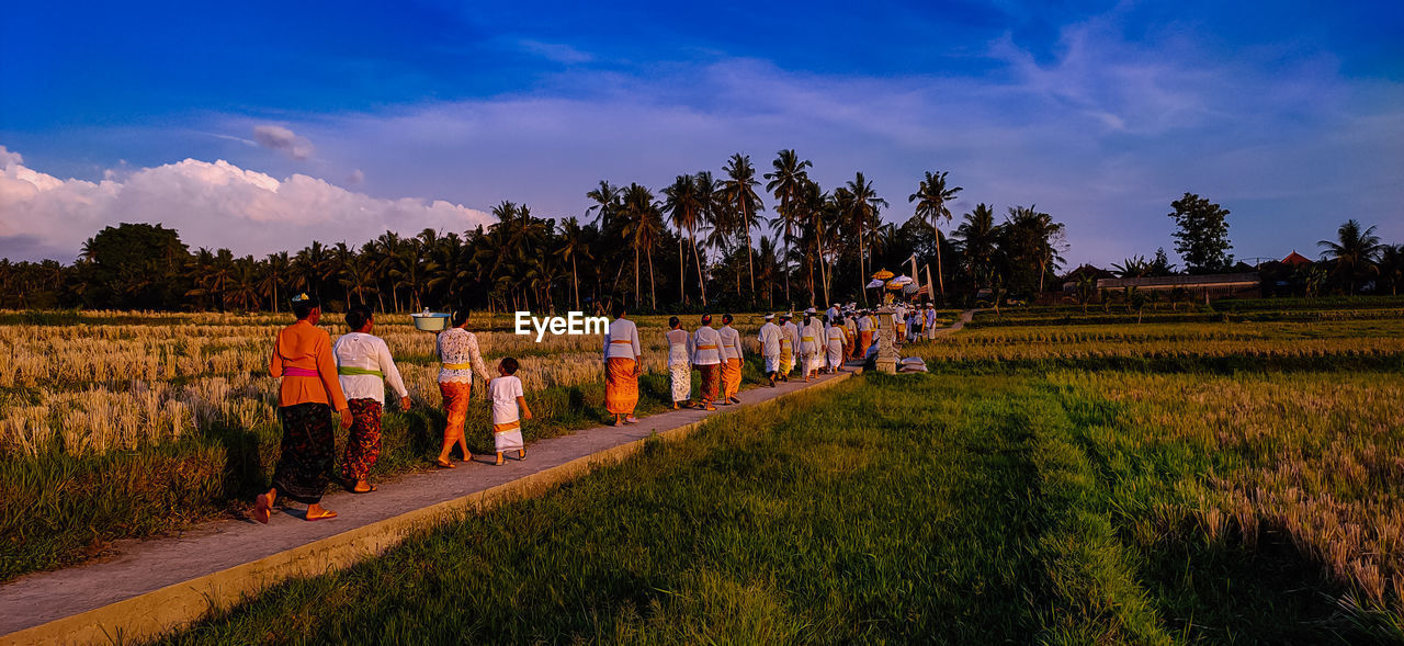 Rear view of people that following tradition