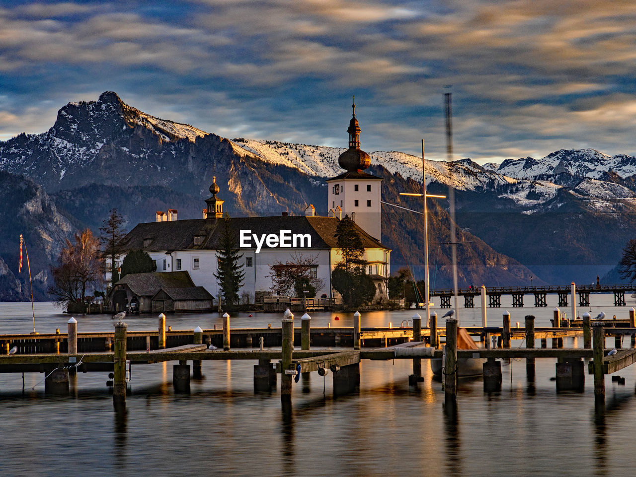 VIEW OF BUILDING BY SNOWCAPPED MOUNTAIN AGAINST SKY