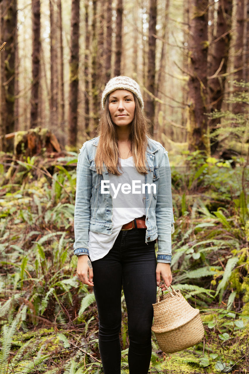 Beautiful woman forages in the rainforest near tofino