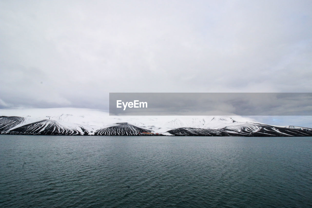 SCENIC VIEW OF SNOWCAPPED MOUNTAIN AGAINST SKY DURING WINTER