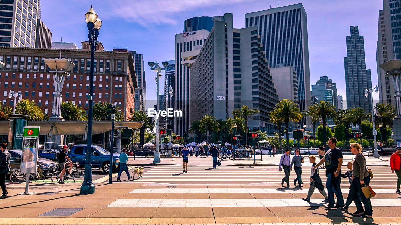 People walking on street amidst buildings in san francisco 