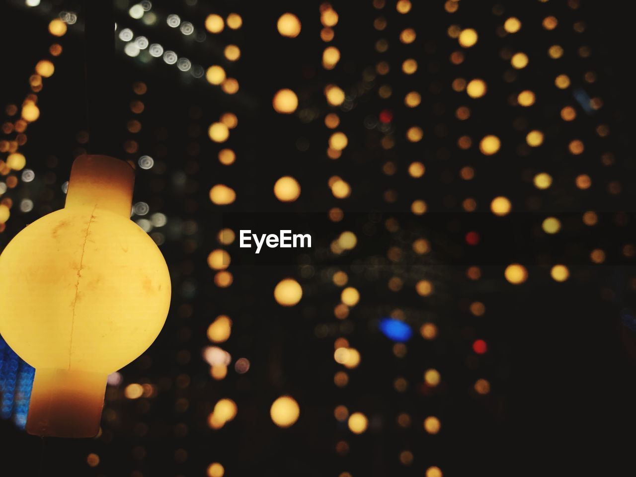 CLOSE-UP OF ILLUMINATED LIGHTING EQUIPMENT HANGING ON CHRISTMAS LIGHTS