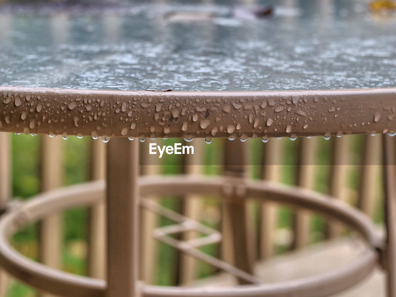 Close-up of water drops on outside patio table