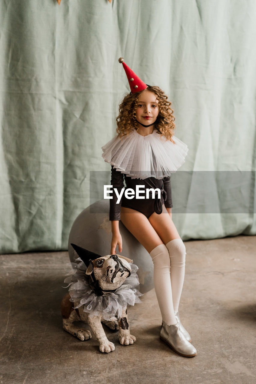 Portrait of child girl in circus clown costume. halloween