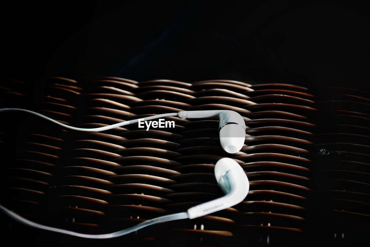 Close-up of headphones on wicker basket