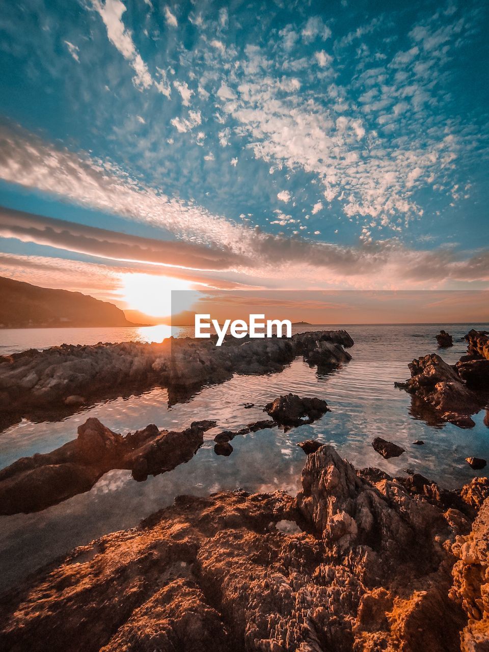 AERIAL VIEW OF SEA AGAINST SKY AT SUNSET