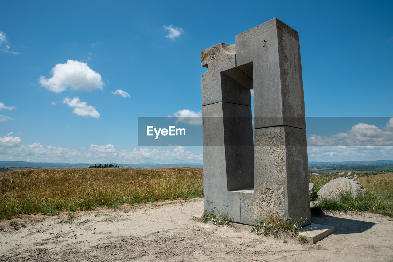 sky, cloud, nature, landscape, land, architecture, blue, no people, scenics - nature, environment, built structure, day, ruins, plant, monument, outdoors, travel destinations, monolith, rock, travel, horizon, rural scene, sunlight, history, grass, tranquility, beach, non-urban scene, tranquil scene, rural area, the past, desert