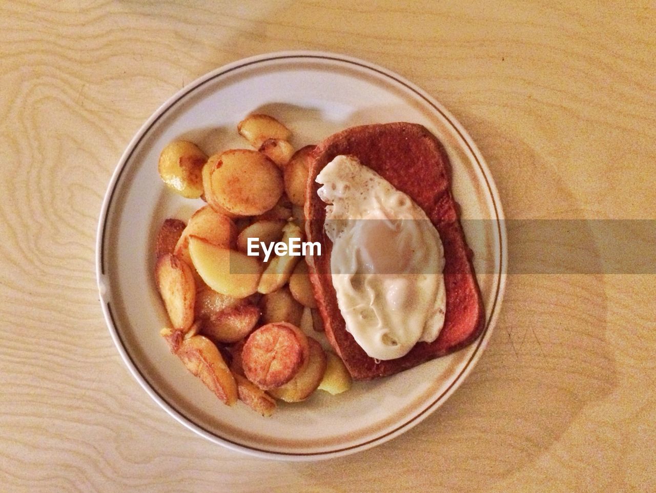 Close-up meatloaf with fried egg and potatoes