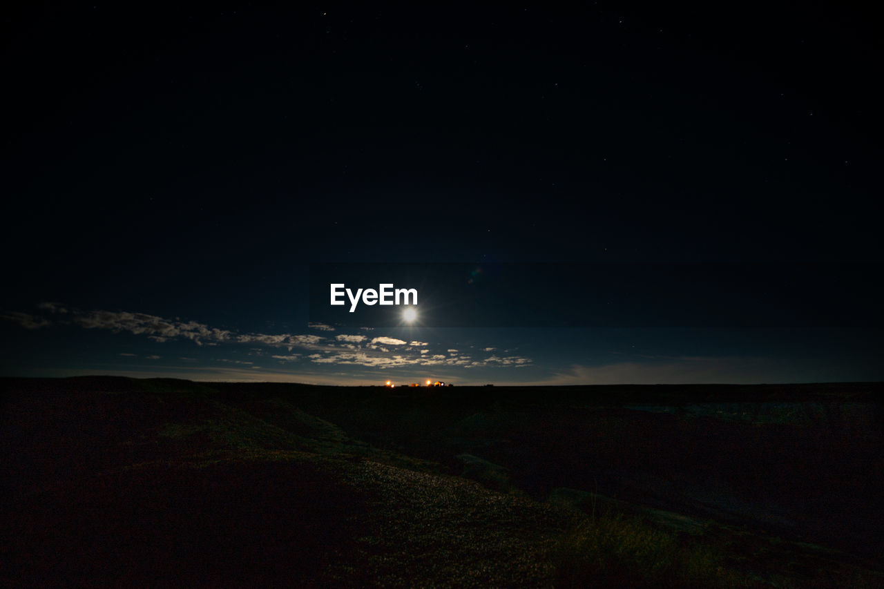 Scenic view of field against sky at night