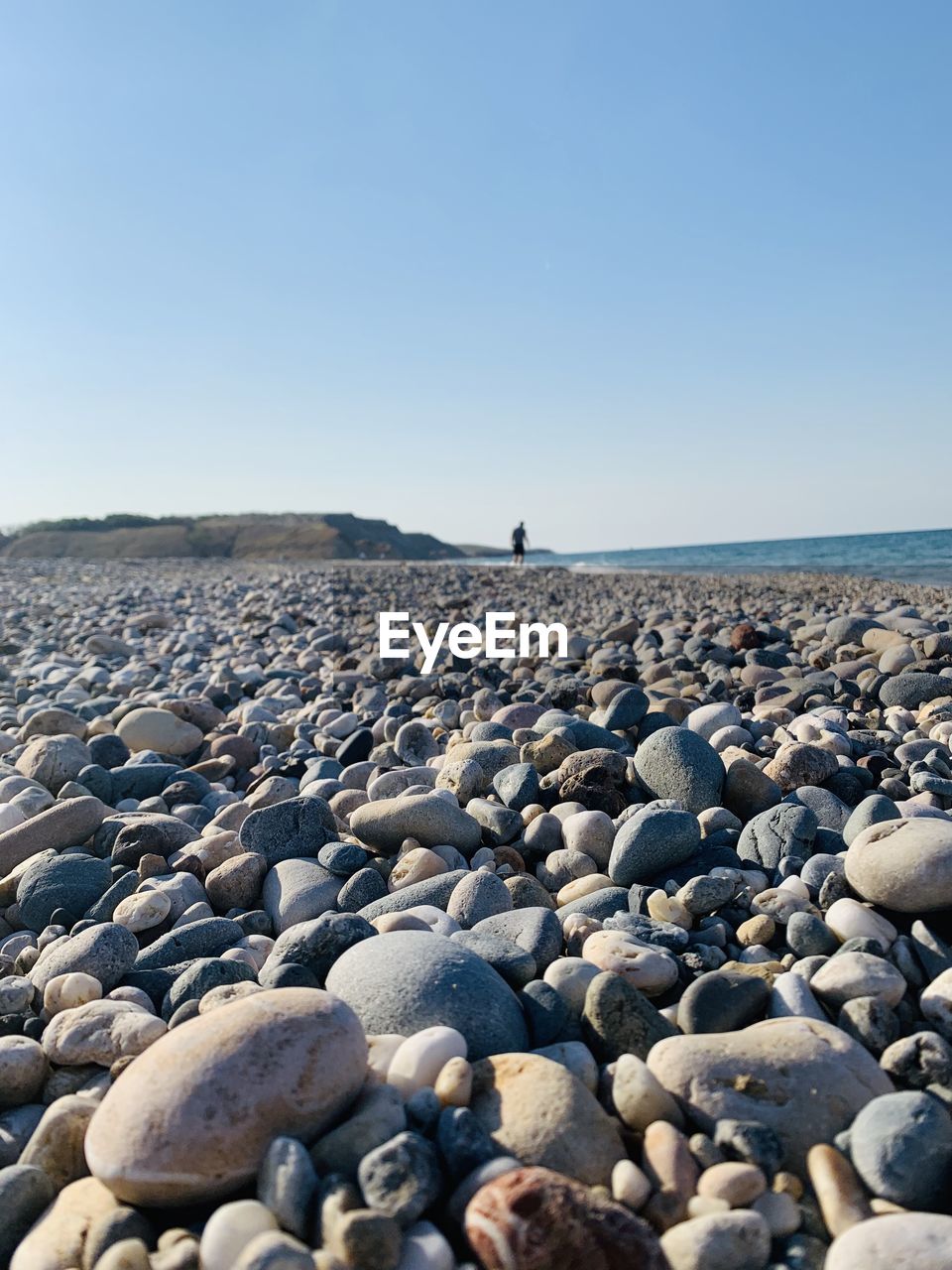 ROCKS ON BEACH AGAINST SKY