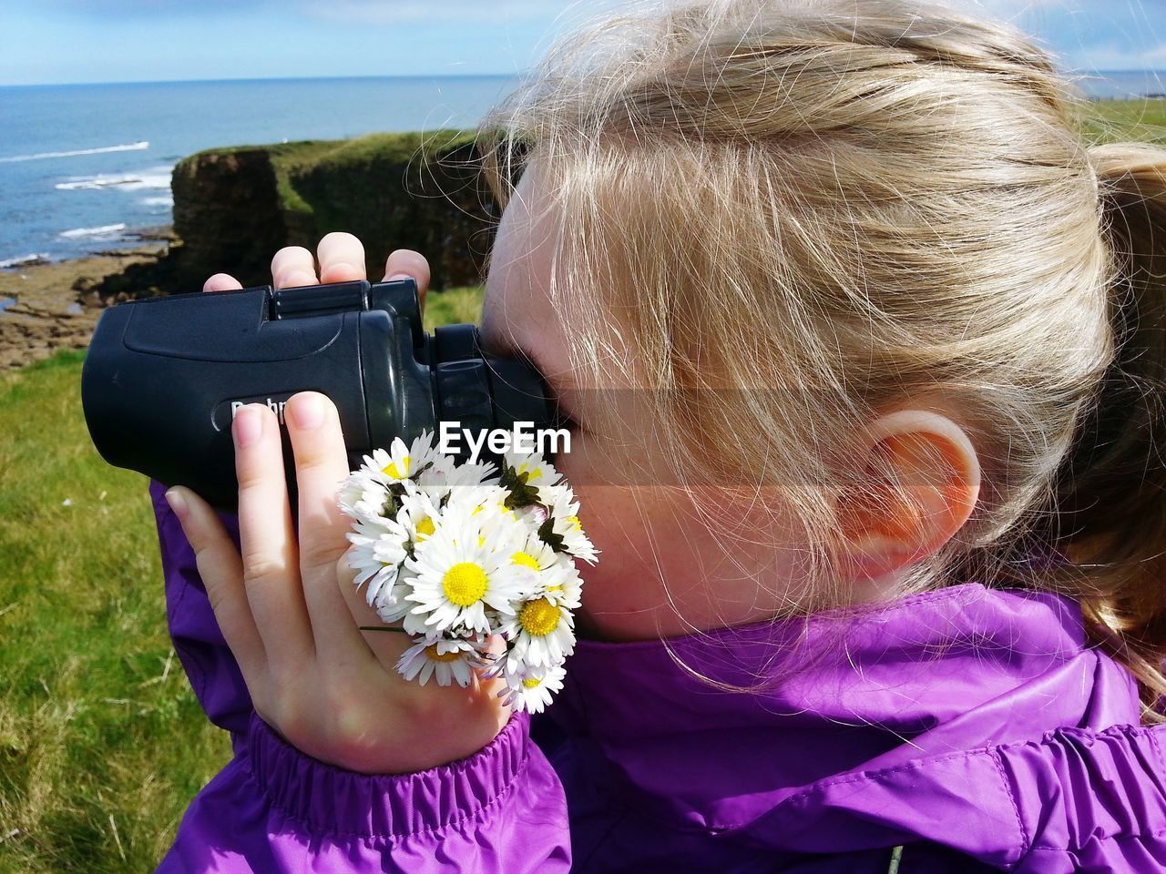 Close-up of girl using binoculars