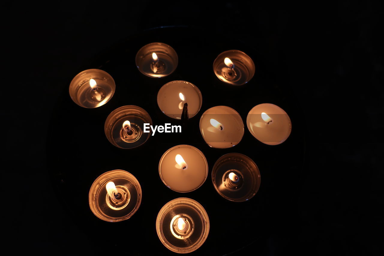 High angle view of candles against black background