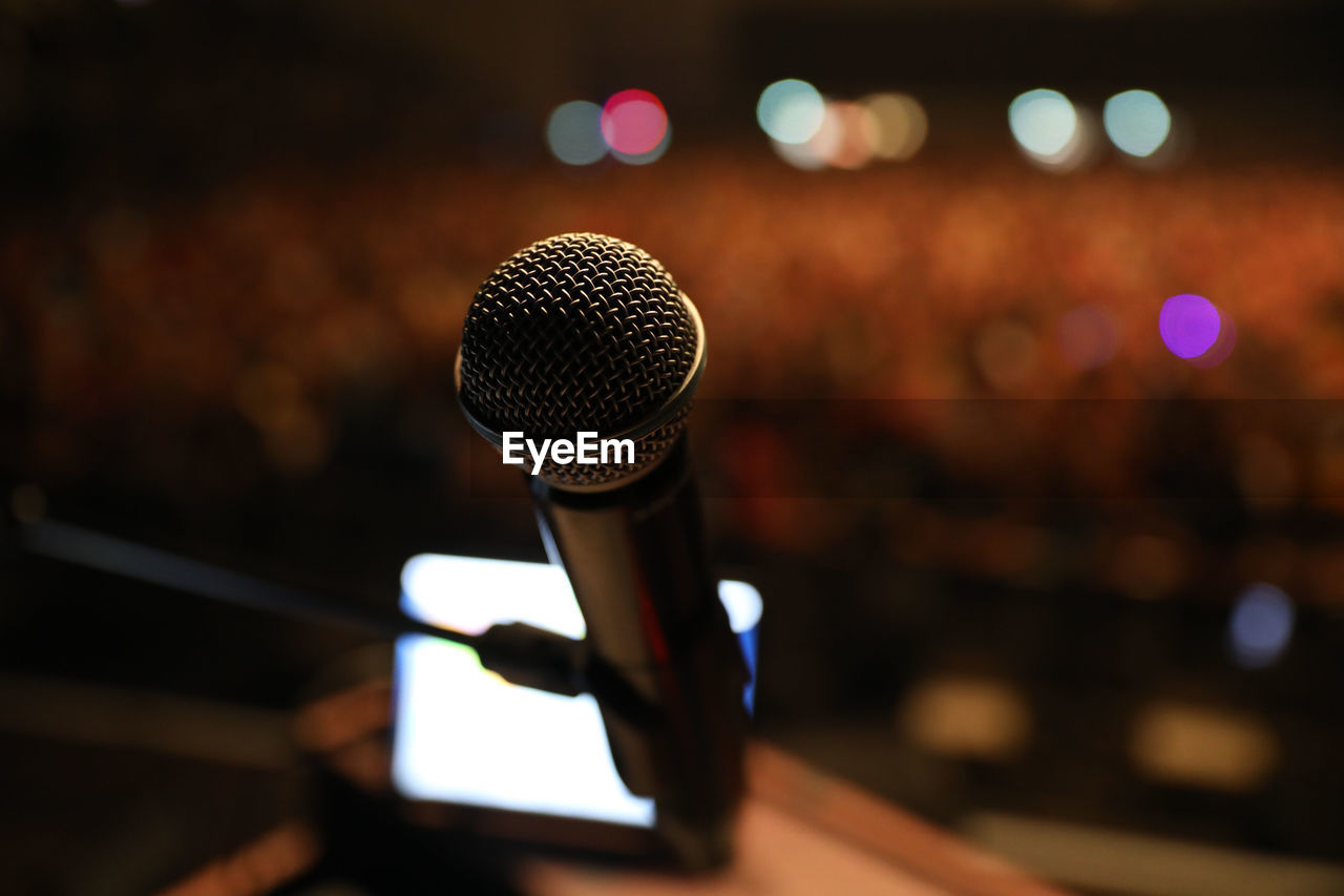 microphone, input device, music, technology, arts culture and entertainment, sound recording equipment, performance, audio equipment, communication, light, talking, stage, recording studio, speech, indoors, night, focus on foreground, broadcasting, event, studio, microphone stand, public speaker